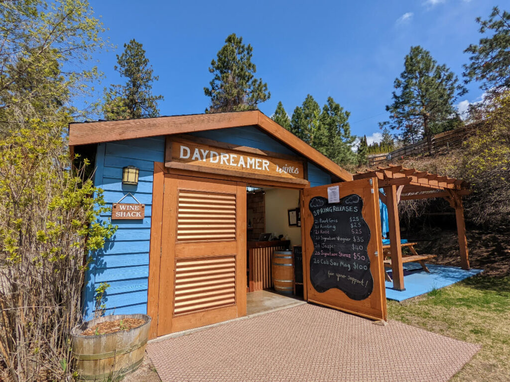 Daydreamer Wine Shack exterior, a bright blue single storey building with wide wooden door