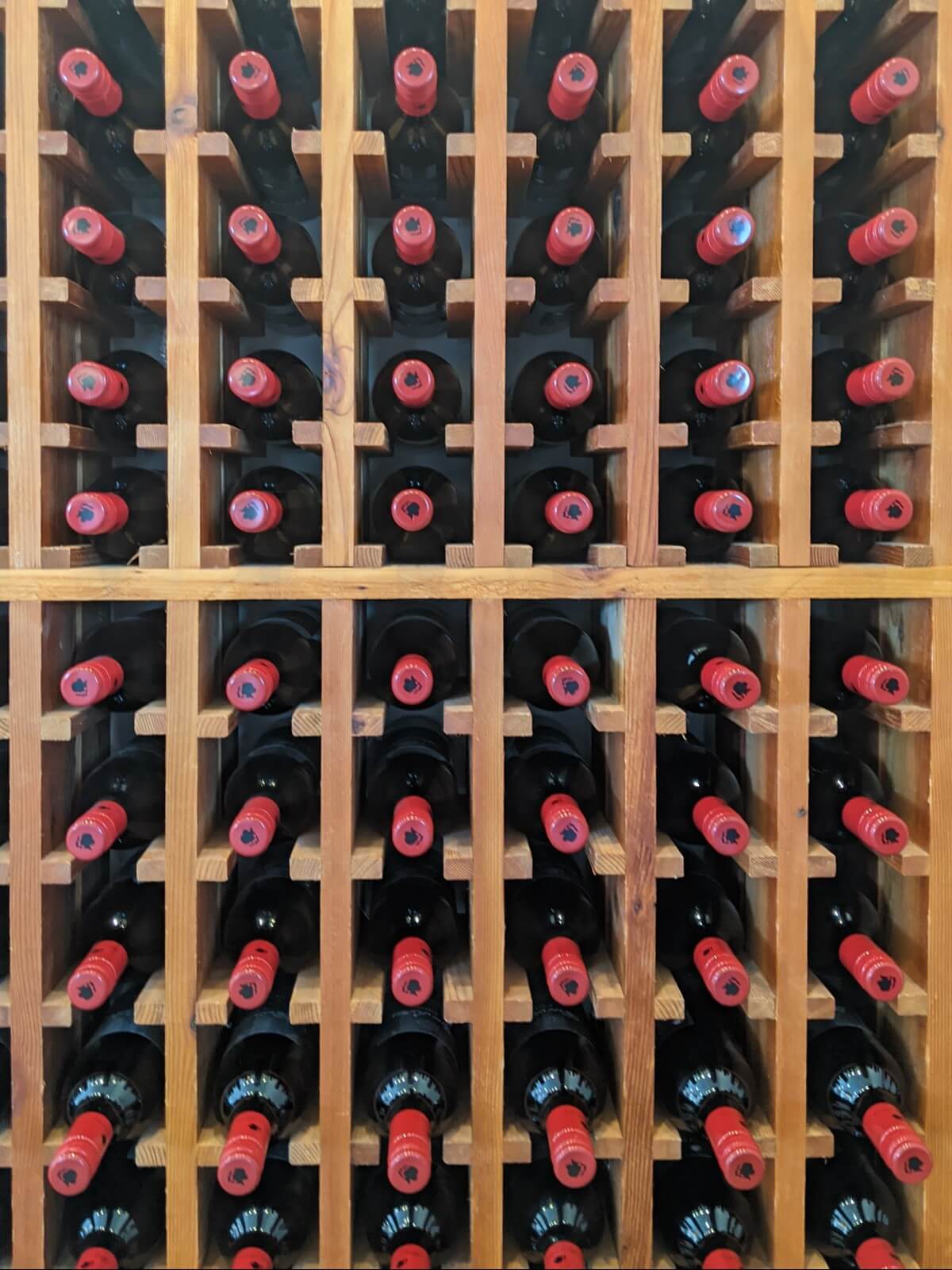 Vertical photo of wine cabinet, filled with wine bottles