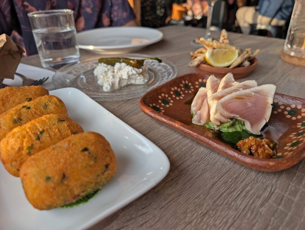 Close up of multiple dishes at the Kitchen restaurant at Da Silva winery, featuring tuna, fried fish and cheese