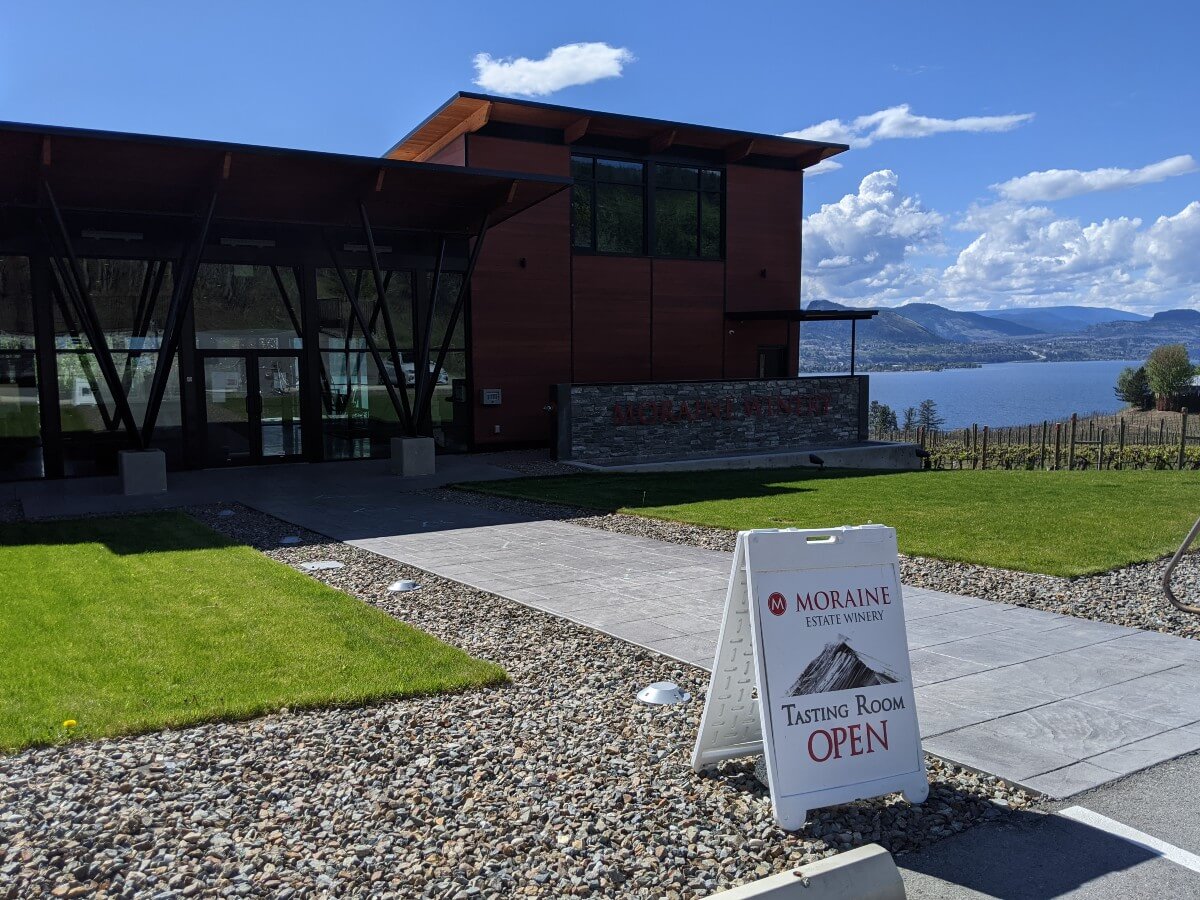 Outside view of Moraine Winery's beautiful new two story tasting room and wine shop, with views of vineyards and Okanagan Lake visible to the right 