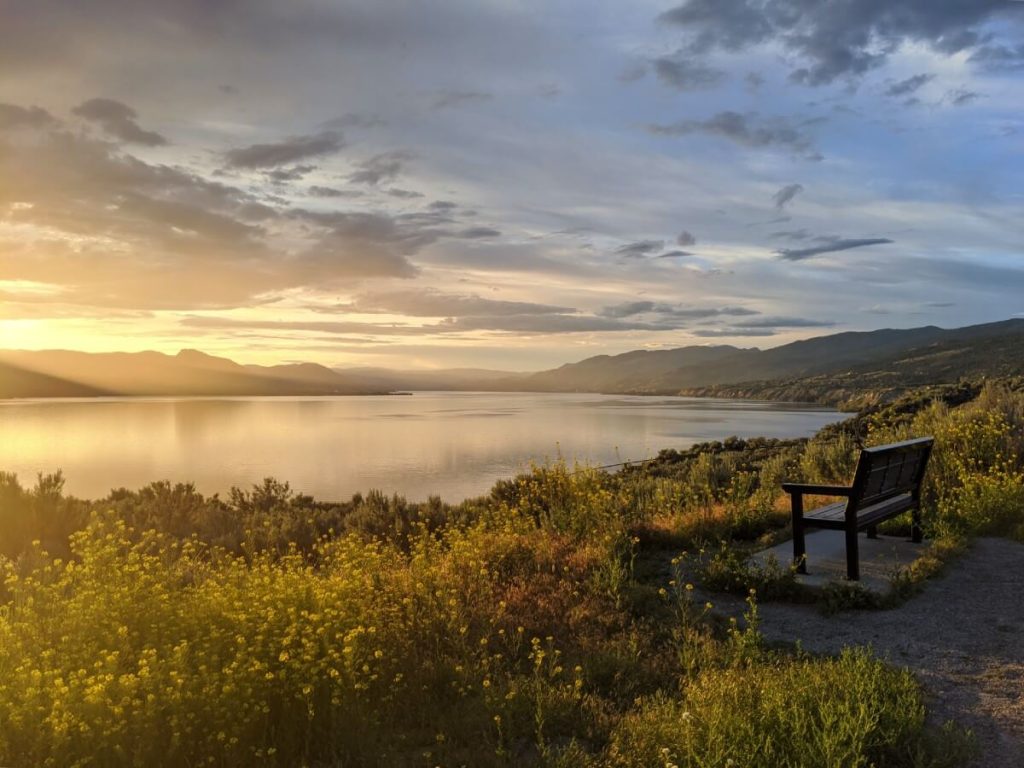 Bench in front of beautiful Okanagan Lake view at sunset in Penticton, British Columbia