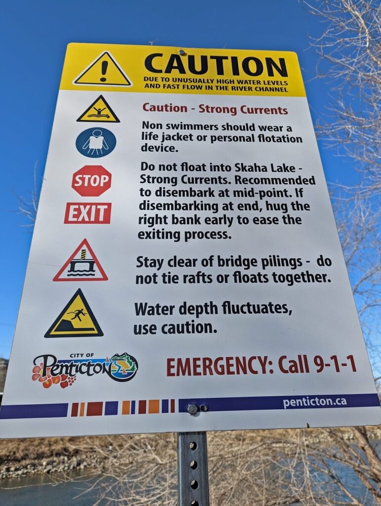Close up of Penticton Channel Float Caution sign with safety advice from the City of Penticton