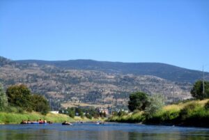People floating on inflatable tubes on the Penticton Channel, British Columbia