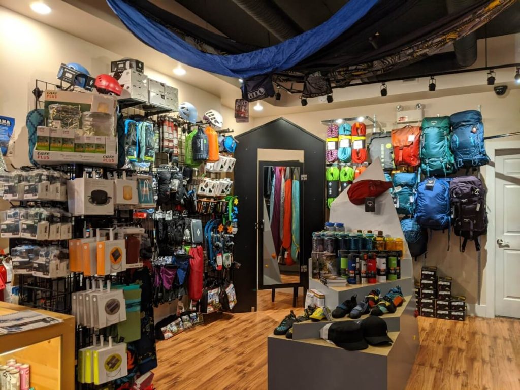 View from outdoor gear displayed on wall and shelves at Eskala Mountain Sports store in Penticton. 