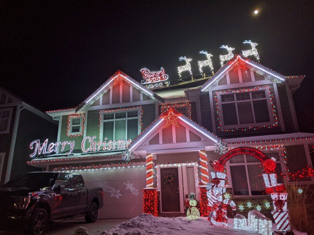 Two storey house with colourful Christmas light displays in Penticton