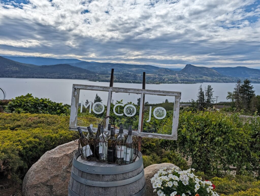 Close up of Mocojo Winery logo in front of beautiful Okanagan Lake view
