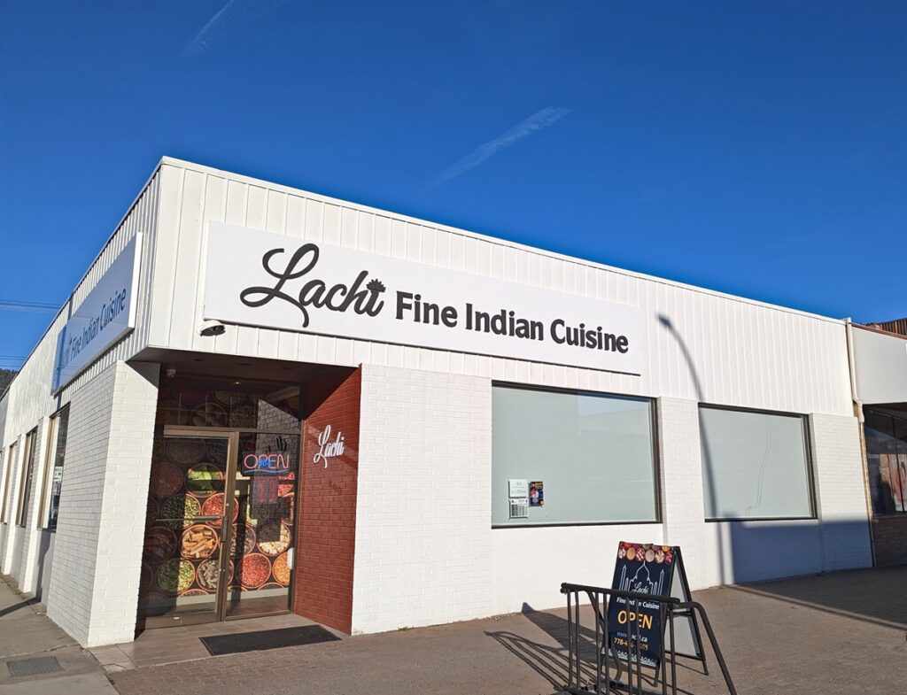 Exterior of Lachi Fine Indian Cuisine restaurant in Penticton, a white coloured single storey corner building 