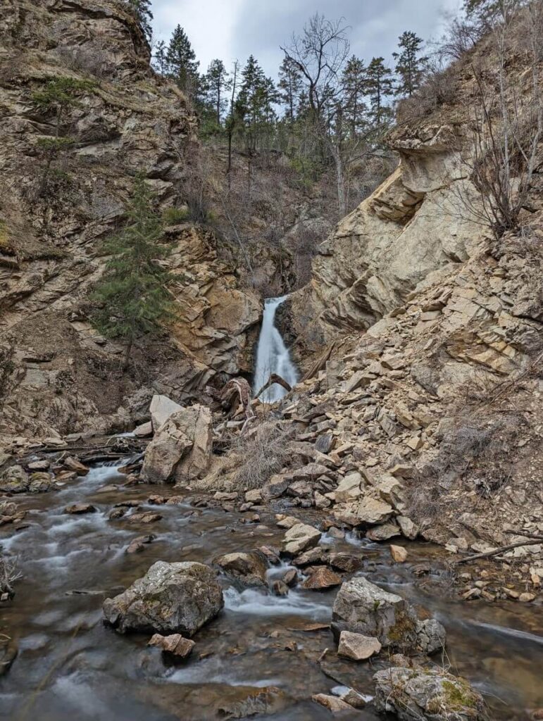 Looking upstream through canyon to small waterfall cascading from shelf