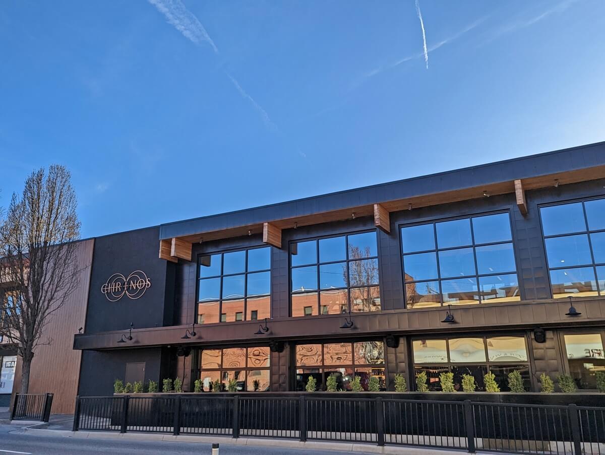TIME Family of Wines building in downtown Penticton, a high two storey building with mirrored floor to ceiling windos, logo on left