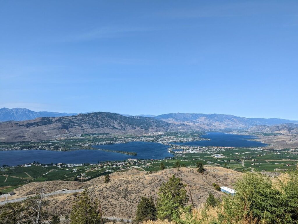 Looking down to the town of Osoyoos and Osoyoos Lake, with brown coloured hills surrounding the settlement